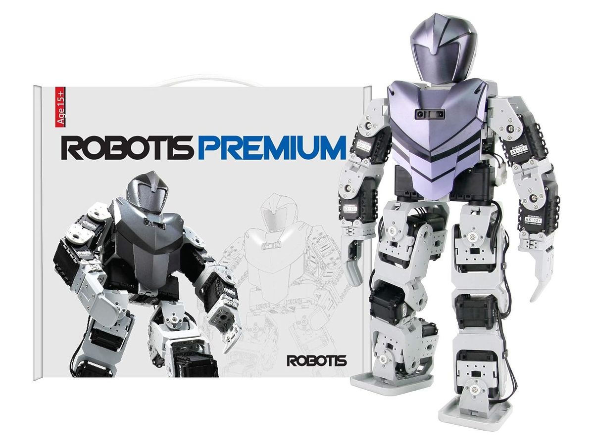 Aufgebauter Humanoidroboter aus grau-weißen Rahmenteilen und schwarzen Servos mit lila Brustpanzer und Helmkopf neben dem Karton „ROBOTIS PREMIUM“.
