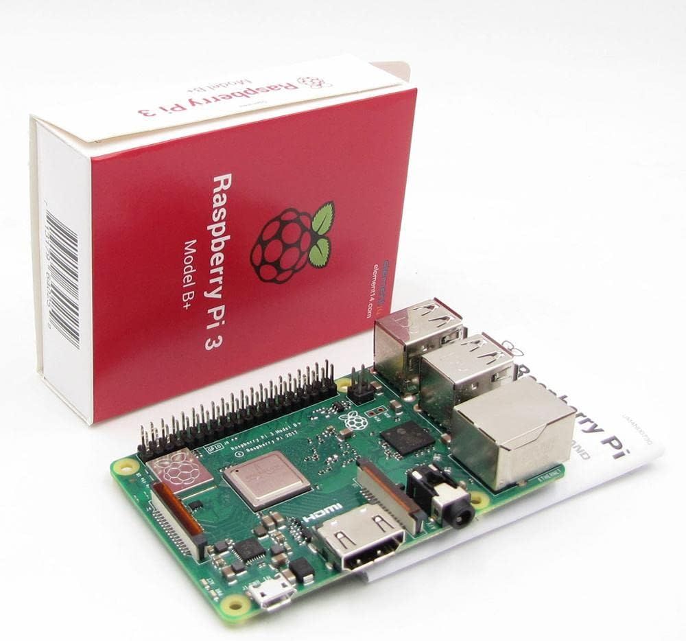 Die grüne Platine des Raspberry Pi 3 Model B+ vor der roten Verpackung mit Himbeer-Logo