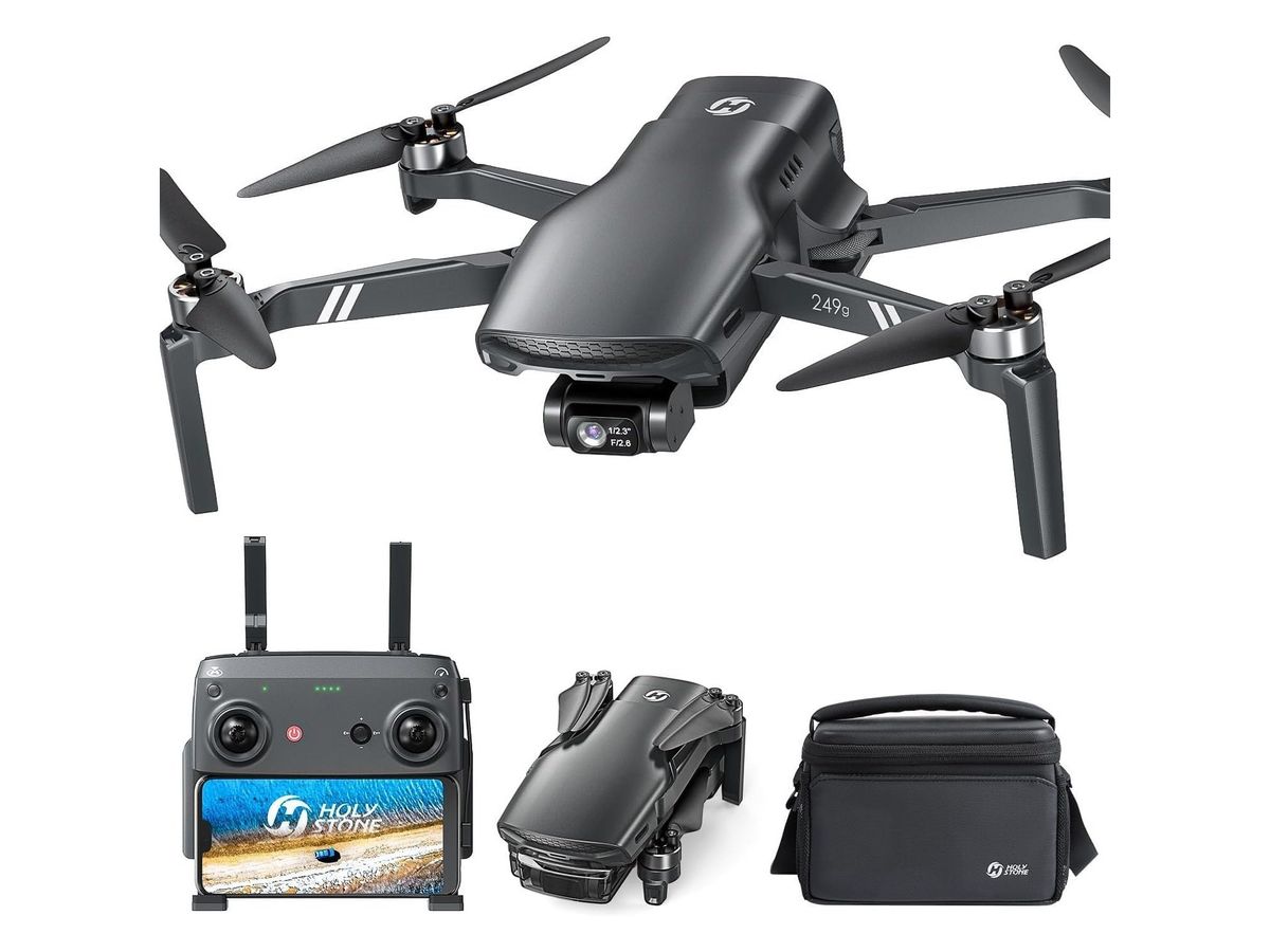 Die dunkelgraue HS900 mit Gimbal-Kamera und ausgeklappten Armen über Fernsteuerung mit Smartphone, gefalteter Drohne und Umhängetasche.