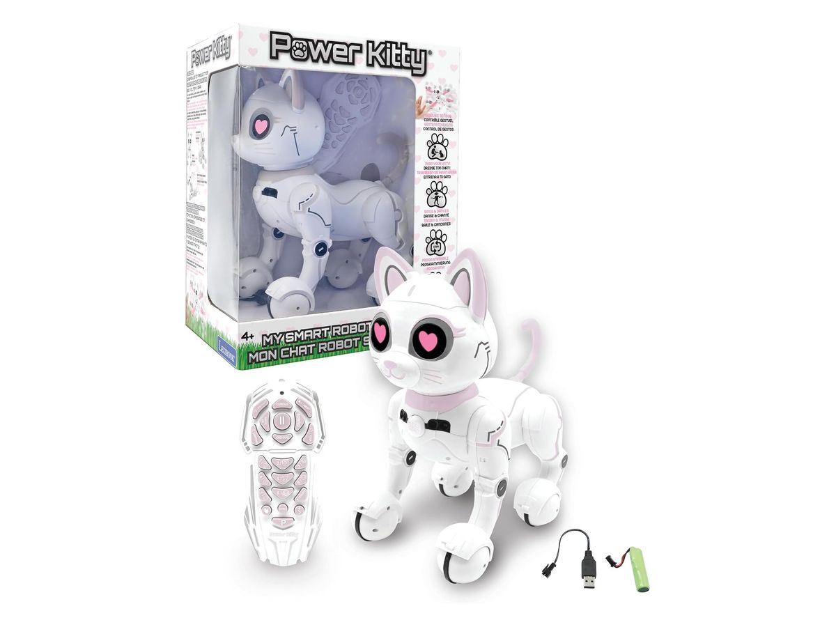 Weiße Roboterkatze Power Kitty mit rosa Herzaugen vor ihrer Verpackung, daneben Fernbedienung, Akku und Ladekabel