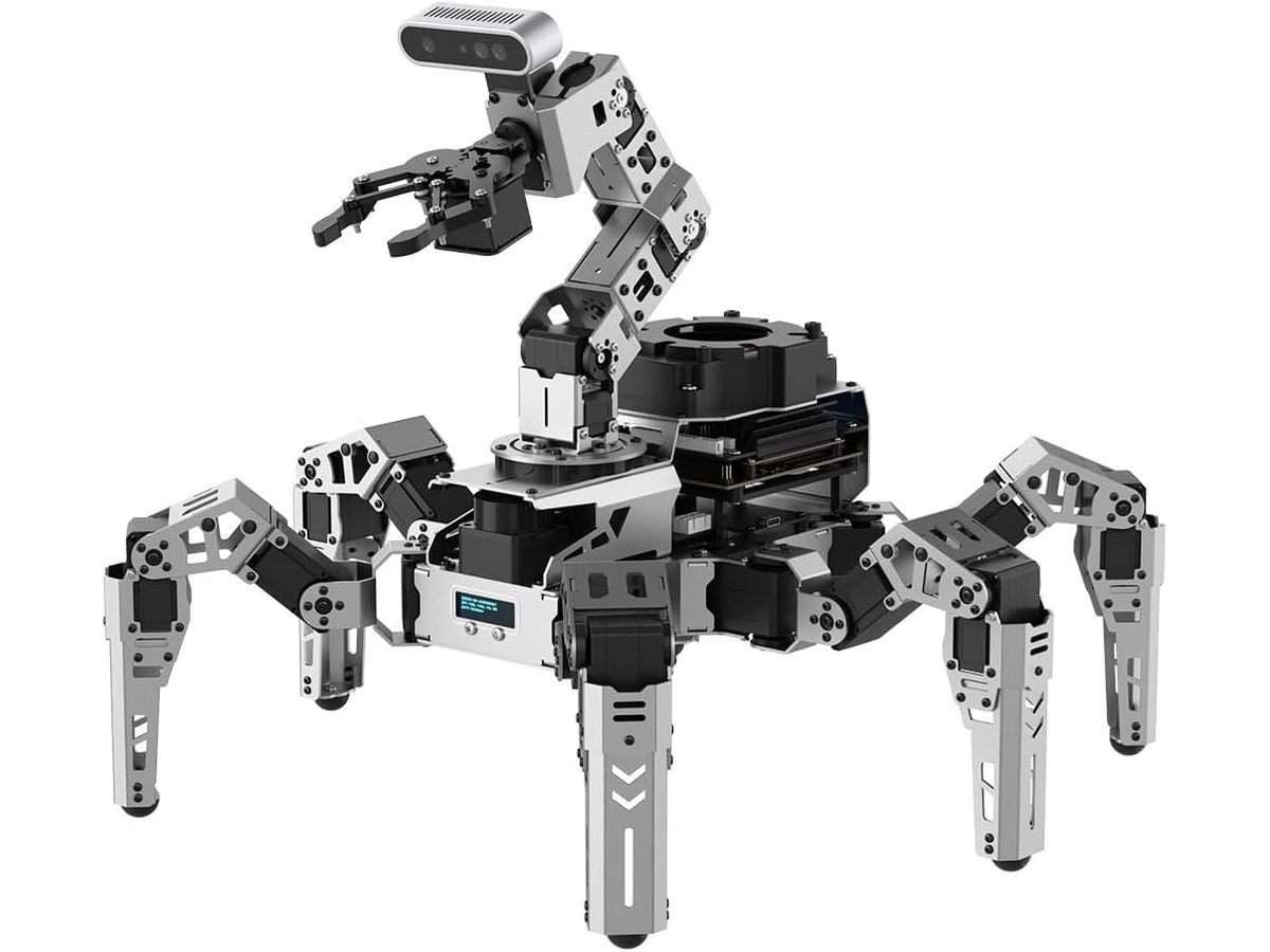 Sechsbeiniger Roboter ROSpider aus silbernem Aluminium mit Greifarm und Tiefenkamera auf dem Rücken, kleinem Display an der Front und Steuerrechner im Gehäuse.